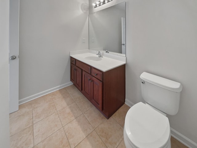 bathroom featuring tile patterned floors, vanity, and toilet