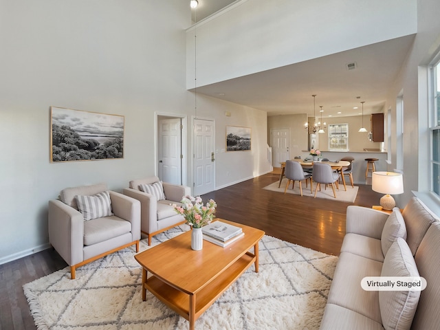 living room featuring hardwood / wood-style floors and a notable chandelier