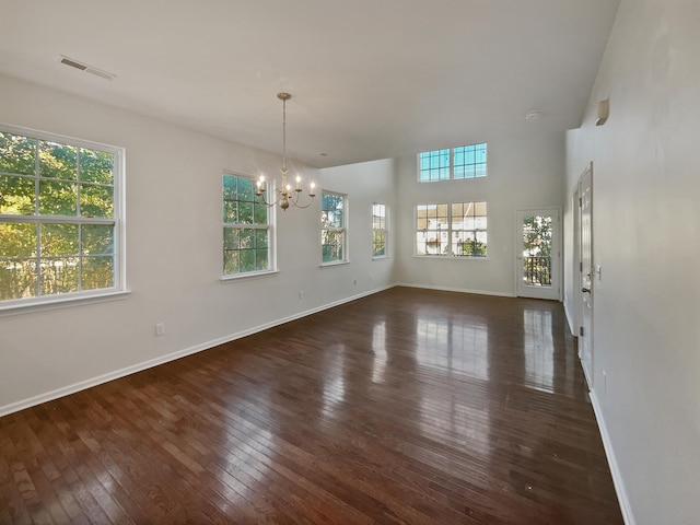 interior space featuring a notable chandelier and dark hardwood / wood-style flooring