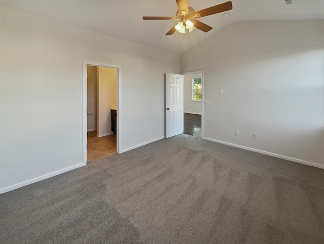 unfurnished bedroom featuring carpet floors, ensuite bathroom, ceiling fan, and lofted ceiling