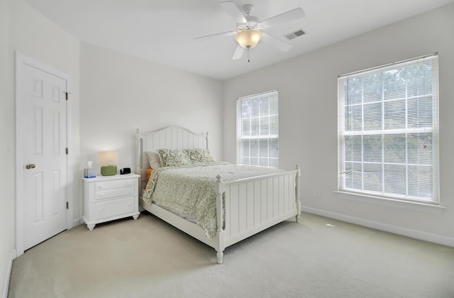 bedroom featuring light carpet and ceiling fan