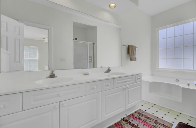 bathroom with vanity and plus walk in shower