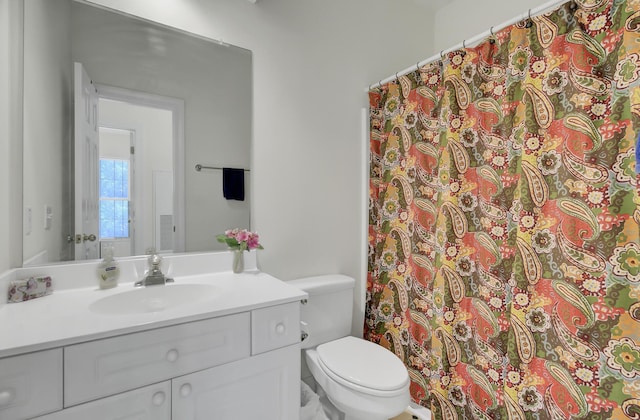 bathroom featuring vanity and toilet