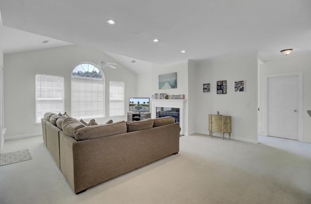 living room featuring ceiling fan, light colored carpet, and lofted ceiling