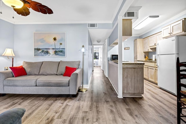 living room with ceiling fan, light hardwood / wood-style flooring, and crown molding