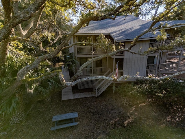 back of property featuring a balcony