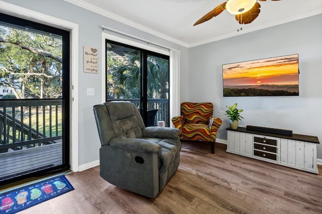 living area featuring ceiling fan, crown molding, and hardwood / wood-style flooring