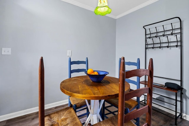 dining area featuring dark hardwood / wood-style flooring and crown molding