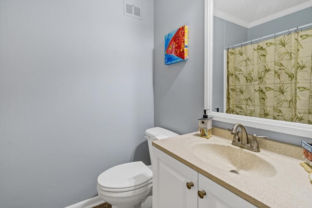 bathroom featuring toilet, ornamental molding, and vanity