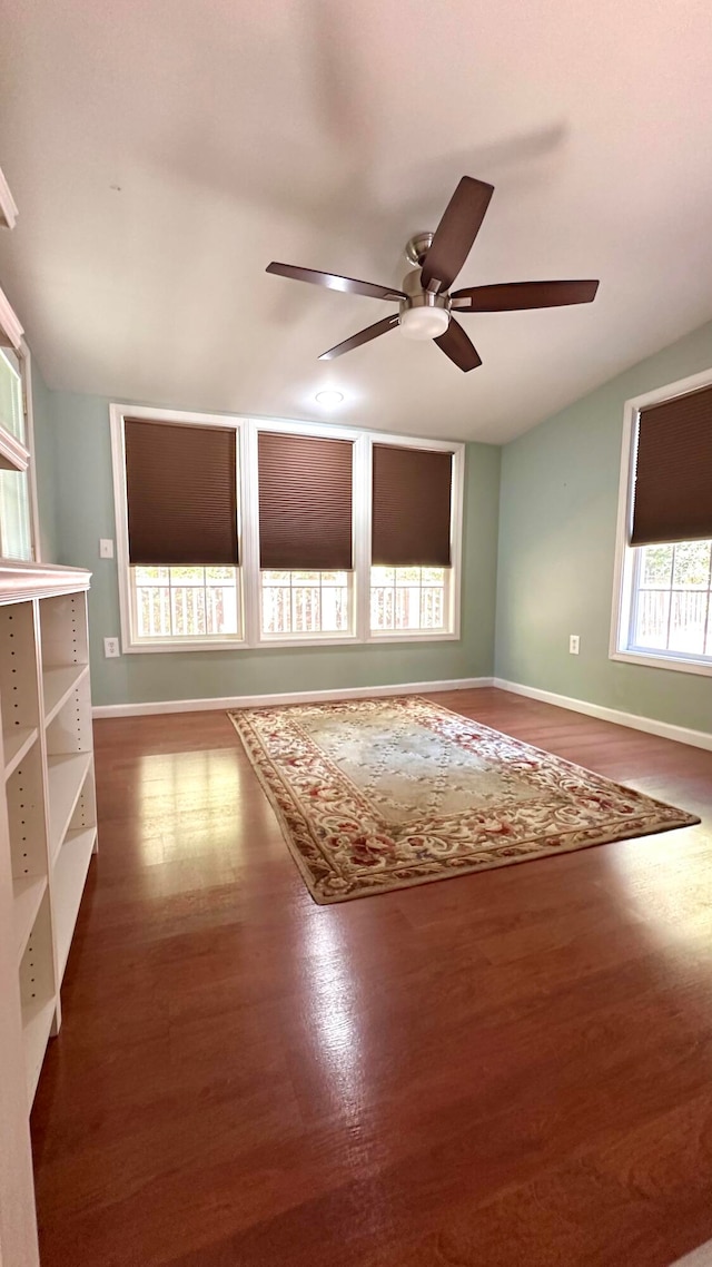 empty room with ceiling fan and dark hardwood / wood-style floors