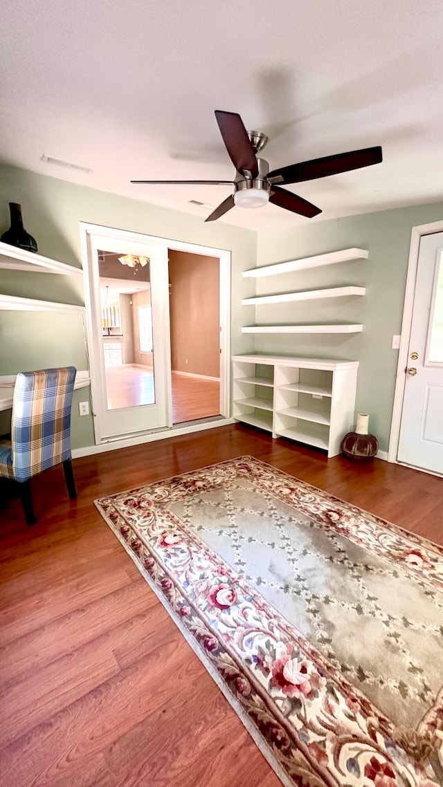 interior space featuring wood-type flooring and ceiling fan