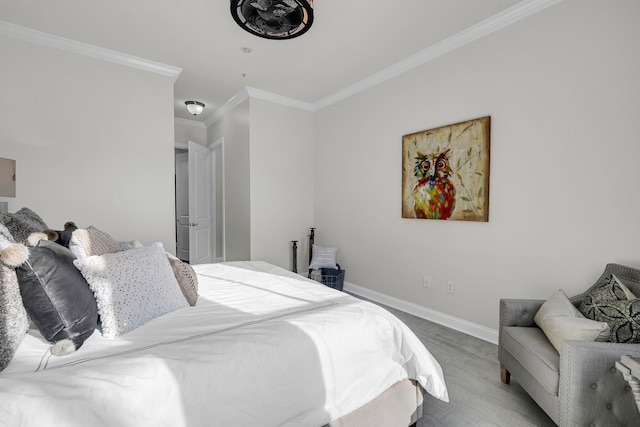 bedroom with crown molding and wood-type flooring