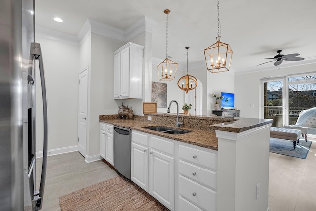 kitchen featuring white cabinetry, sink, dark stone counters, kitchen peninsula, and stainless steel appliances