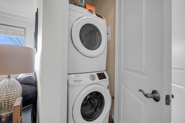 laundry area with stacked washer and clothes dryer