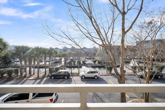 view of parking / parking lot with a water view