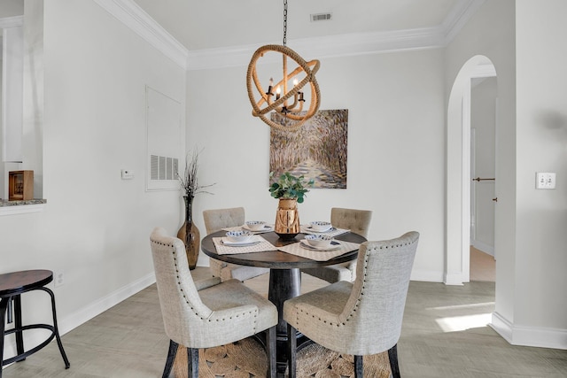 dining area featuring crown molding, wood-type flooring, and an inviting chandelier