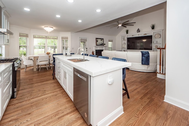 kitchen featuring white cabinets, a sink, range with gas cooktop, ceiling fan, and dishwasher