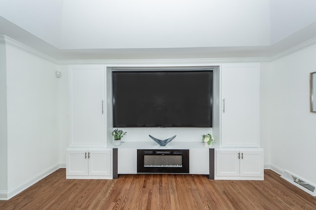 unfurnished living room featuring baseboards, visible vents, and light wood-type flooring