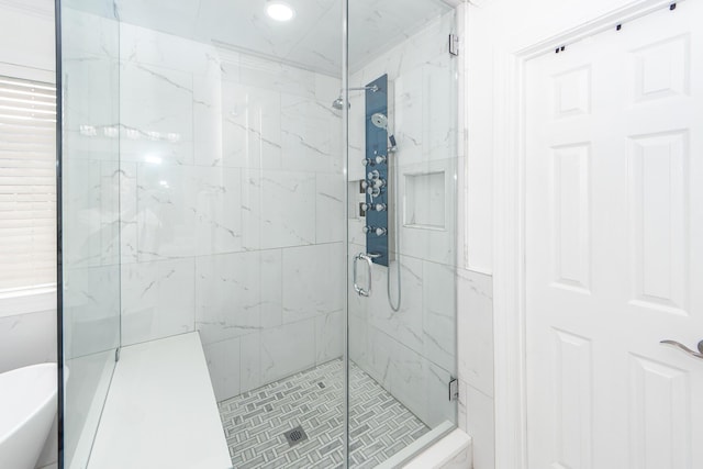 bathroom featuring a marble finish shower and recessed lighting