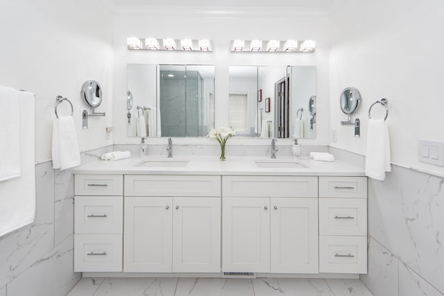 full bath with marble finish floor, a sink, and double vanity