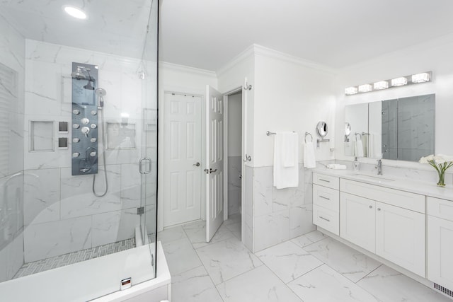 full bathroom featuring a marble finish shower, wainscoting, marble finish floor, crown molding, and vanity