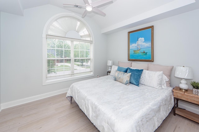 bedroom with lofted ceiling, baseboards, wood finished floors, and ceiling fan