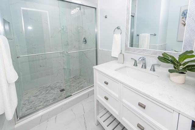 bathroom with marble finish floor, vanity, and a marble finish shower