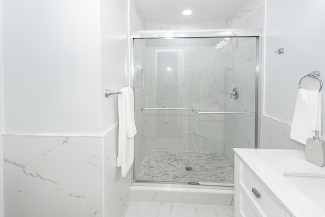 full bathroom with marble finish floor, vanity, a marble finish shower, and recessed lighting