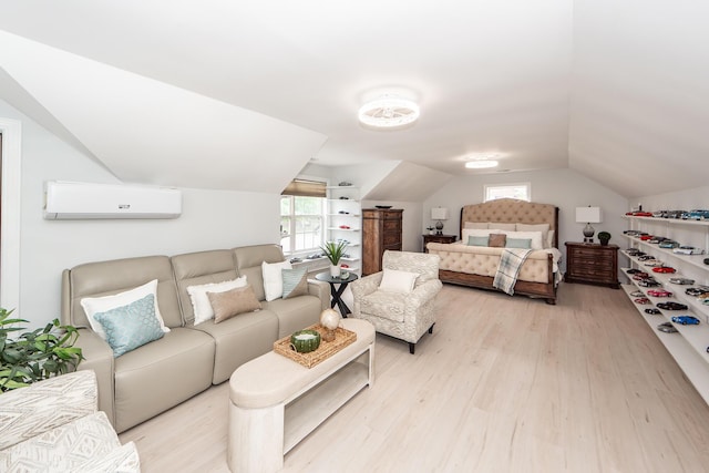 bedroom with vaulted ceiling, wood finished floors, and a wall mounted AC