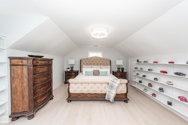 bedroom featuring vaulted ceiling and light wood-style flooring