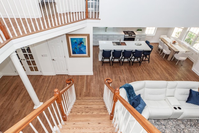 staircase with baseboards and wood finished floors