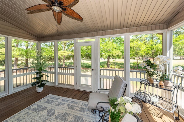 sunroom with wooden ceiling, vaulted ceiling, a ceiling fan, and wood-type flooring