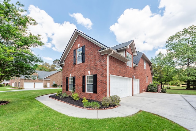 view of home's exterior with brick siding, a yard, a garage, and concrete driveway