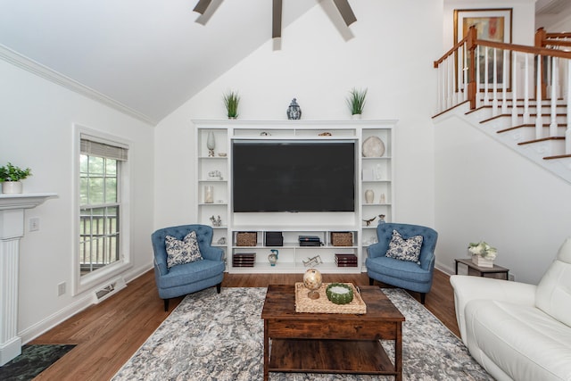 living area featuring stairway, visible vents, wood finished floors, and vaulted ceiling with beams