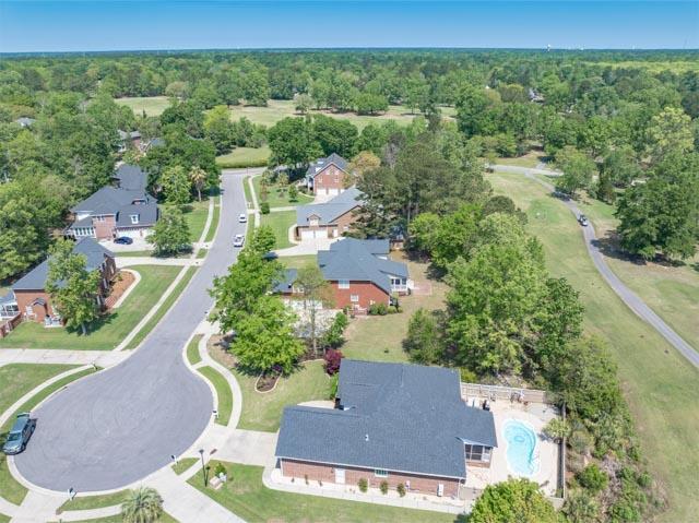 drone / aerial view featuring a wooded view