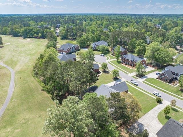 birds eye view of property featuring a wooded view and a residential view