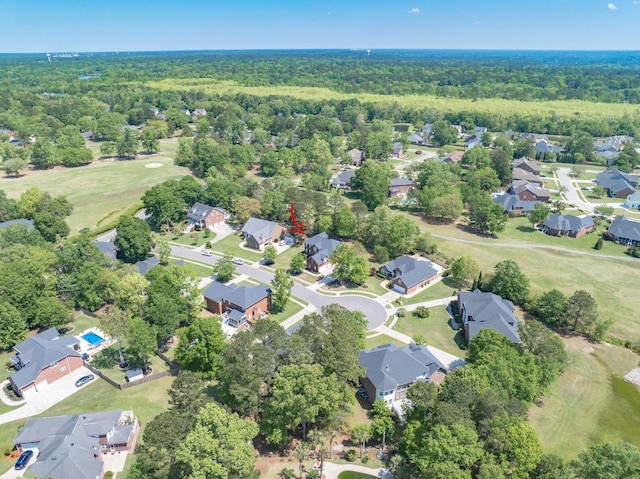 bird's eye view featuring a wooded view and a residential view