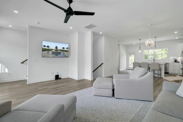 living room featuring ceiling fan and light hardwood / wood-style floors