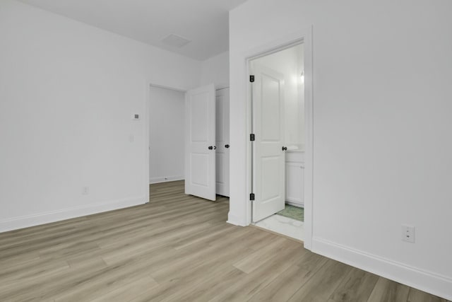 empty room with light hardwood / wood-style floors