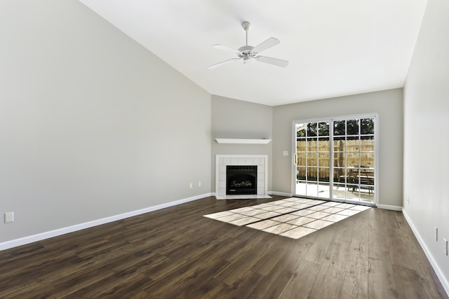 unfurnished living room featuring a fireplace, ceiling fan, and dark hardwood / wood-style flooring