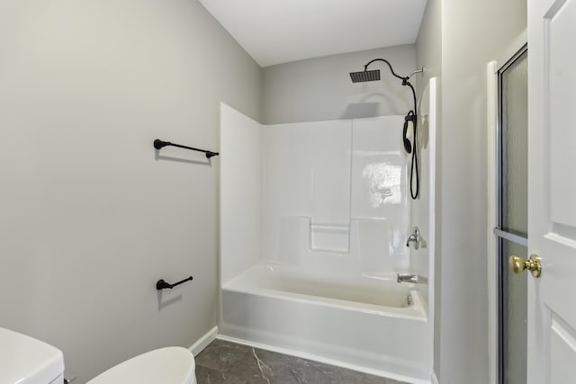 bathroom with tile patterned flooring, shower / bathing tub combination, and toilet