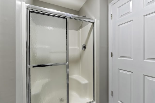 bathroom with a shower with shower door