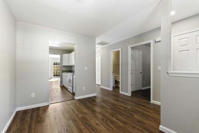 unfurnished living room featuring dark hardwood / wood-style flooring