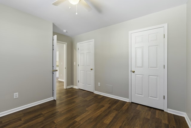 unfurnished bedroom featuring dark hardwood / wood-style floors and ceiling fan