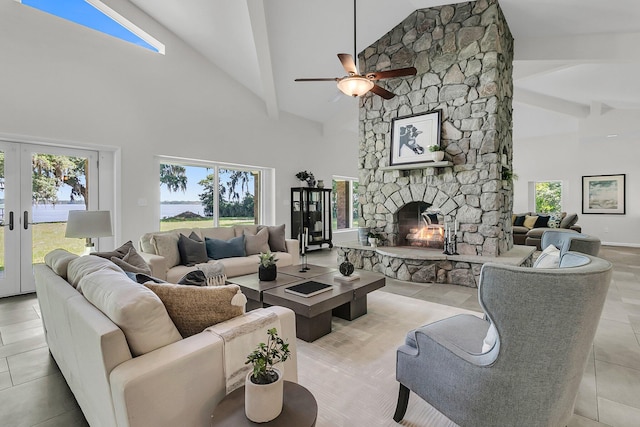 1085 Harts Bluff Rd, Wadmalaw Island, SC 29487 - living room featuring high vaulted ceiling, a stone fireplace, ceiling fan, healthy amount of natural light, and beamed ceiling