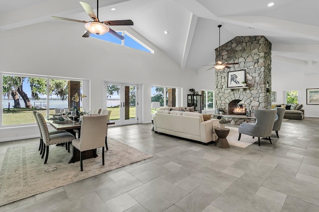 1085 Harts Bluff Rd, Wadmalaw Island, SC 29487 - dining space featuring a ceiling fan, plenty of natural light, a stone fireplace, high vaulted ceiling, and beamed ceiling