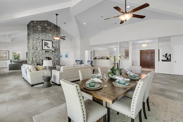 1085 Harts Bluff Rd, Wadmalaw Island, SC 29487 - dining space with a ceiling fan, a stone fireplace, high vaulted ceiling, and beam ceiling