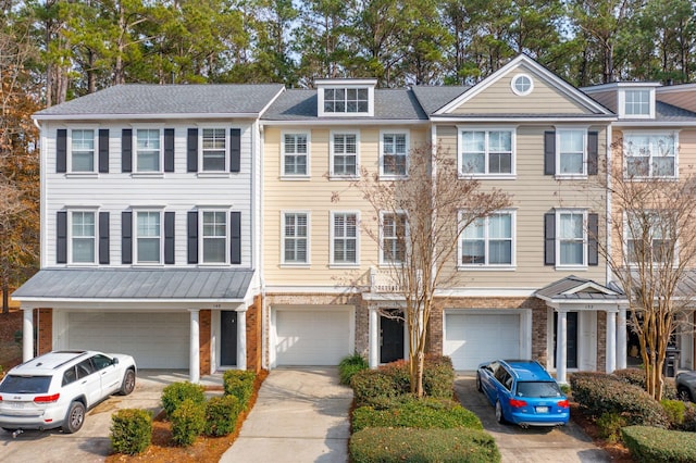 view of property featuring an attached garage and concrete driveway