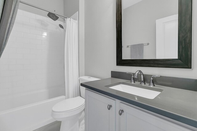 bathroom featuring toilet, vanity, and shower / bathtub combination with curtain