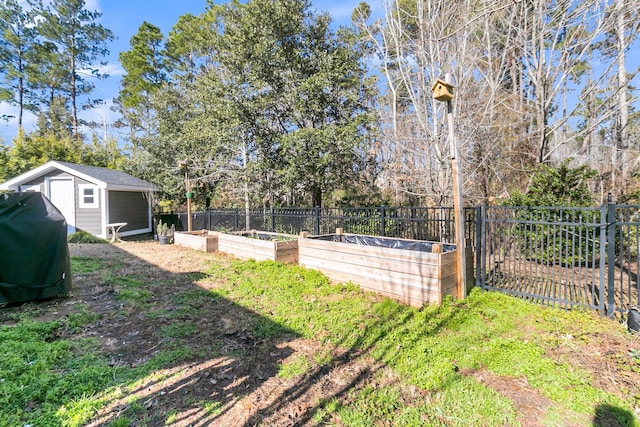 view of yard with fence, a garden, a storage shed, and an outdoor structure